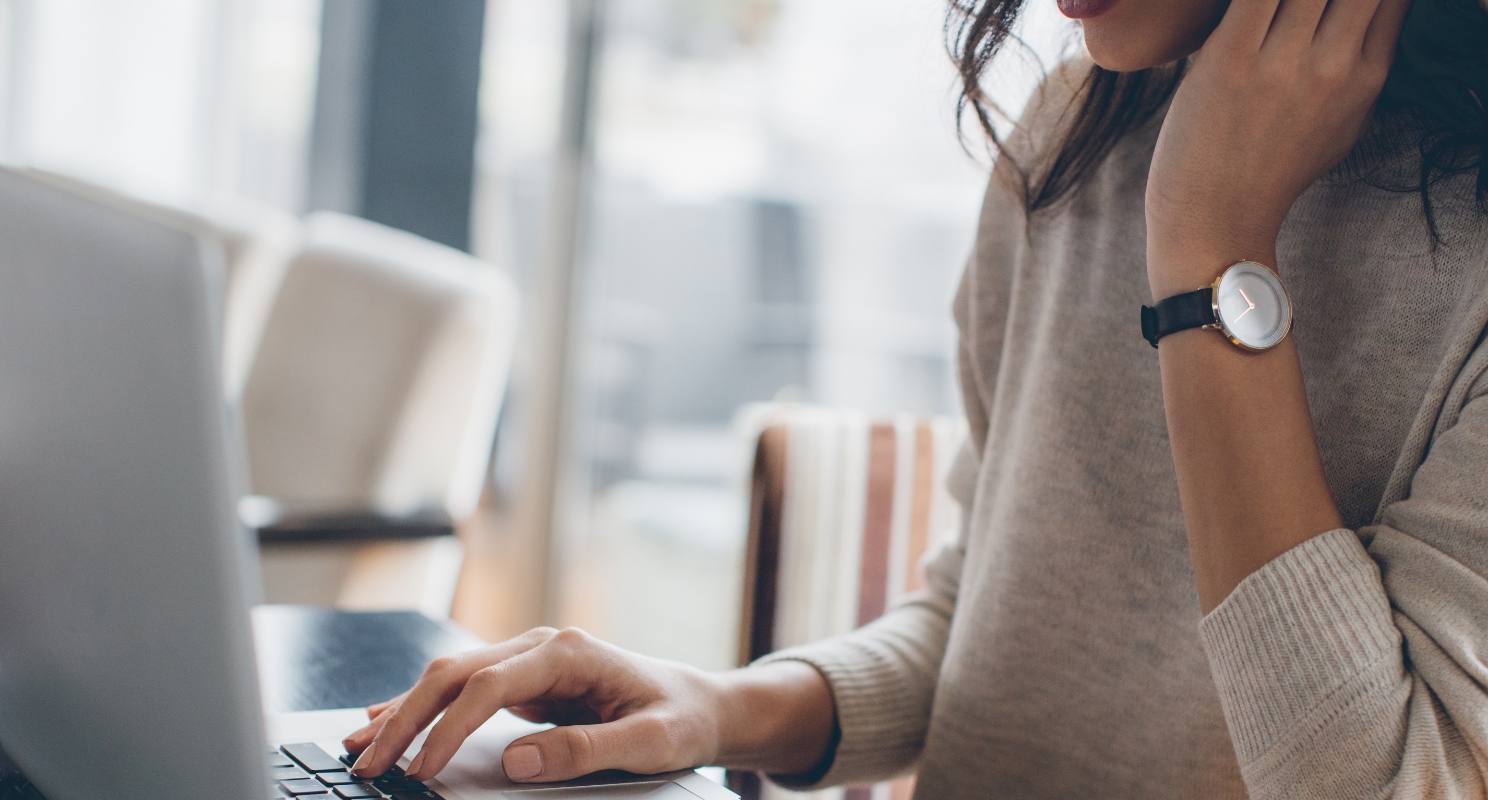 Female student typing cover letter on laptop 