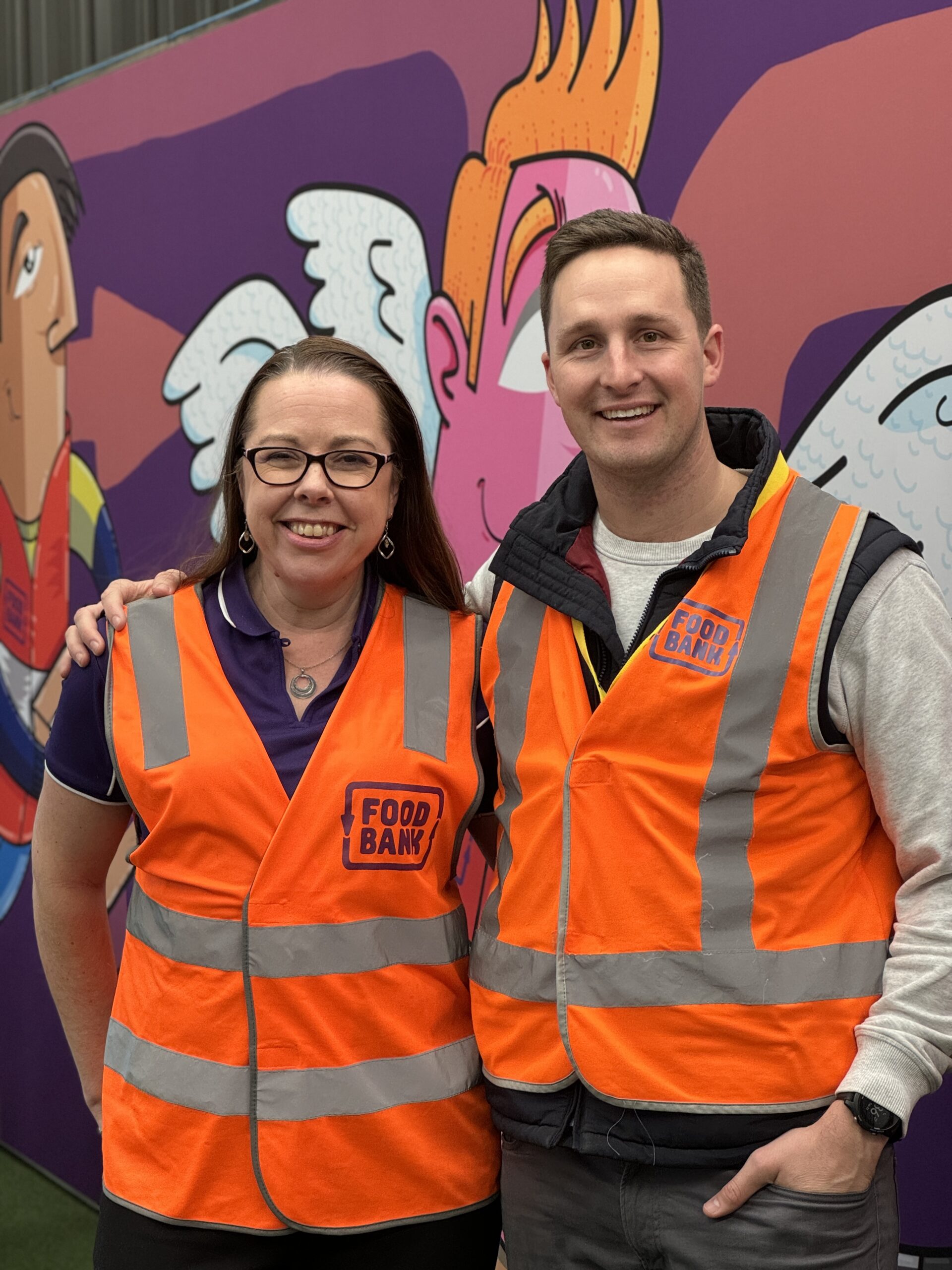 Brianna and Oli wearing Food Bank high vis