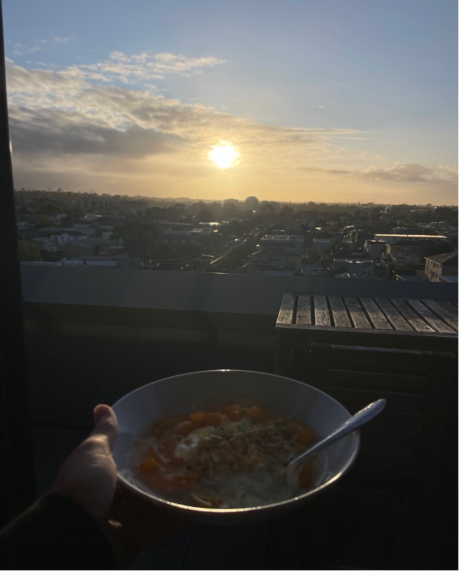 View from balcony of sunrise with cereal bowl