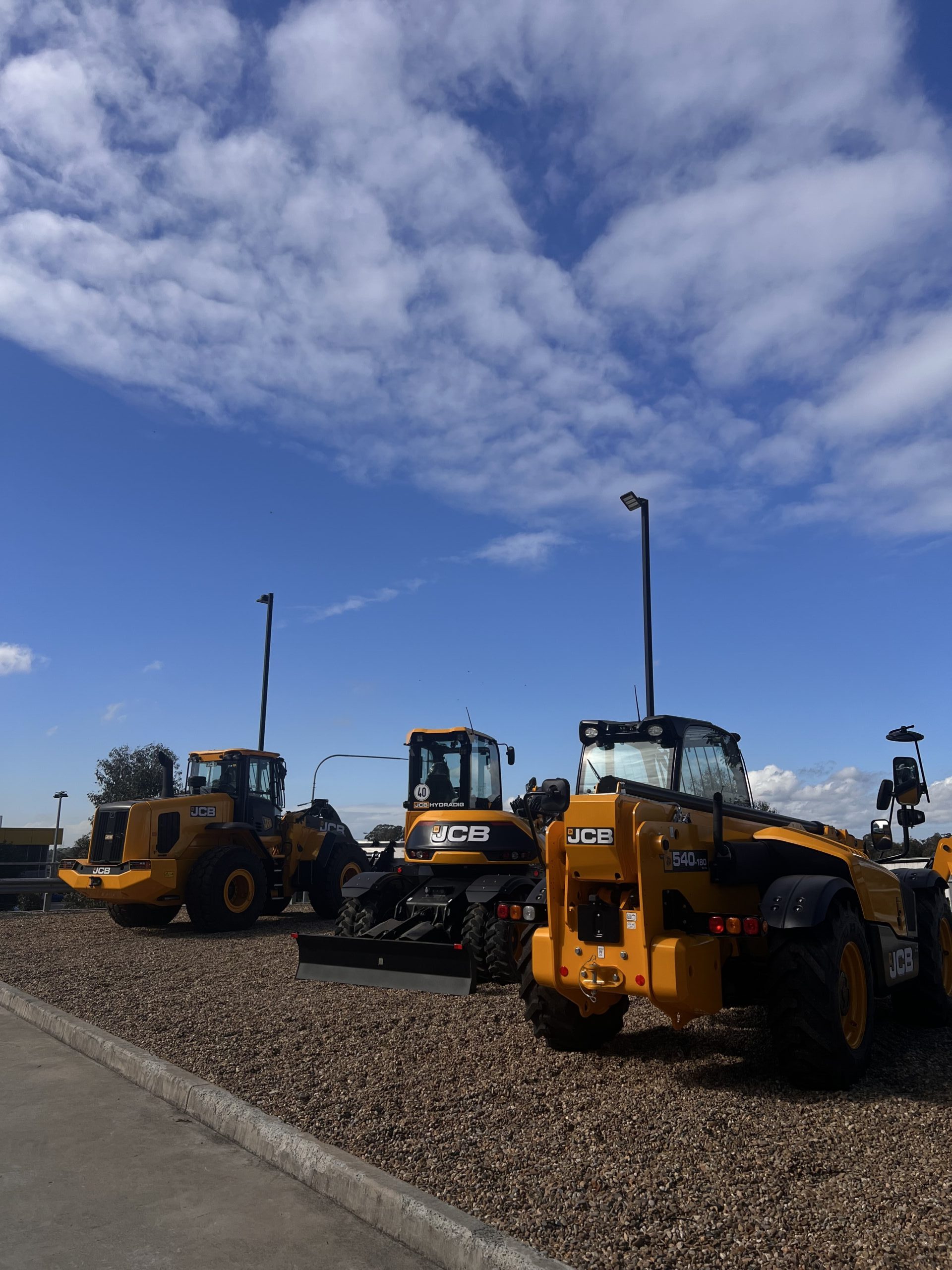 Yellow heavy vehicle machines lined up on-site