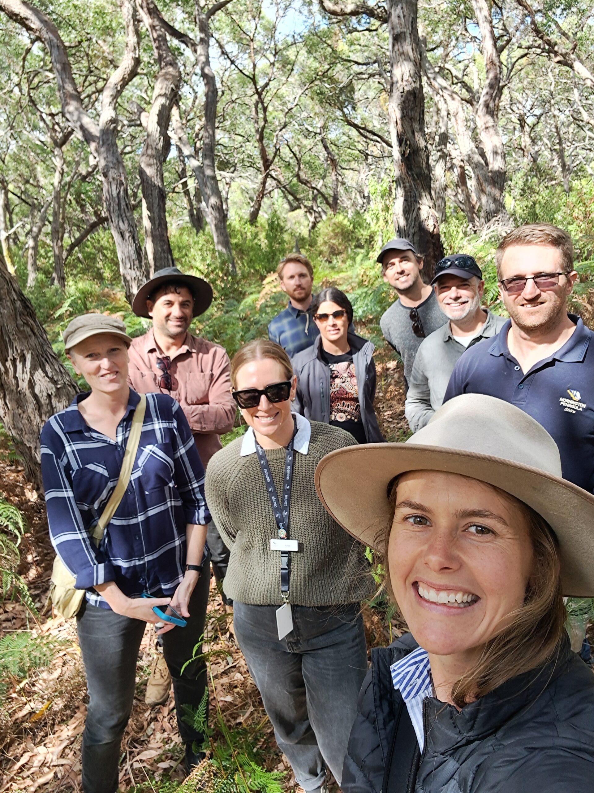 Group selfie in bushy outdoors