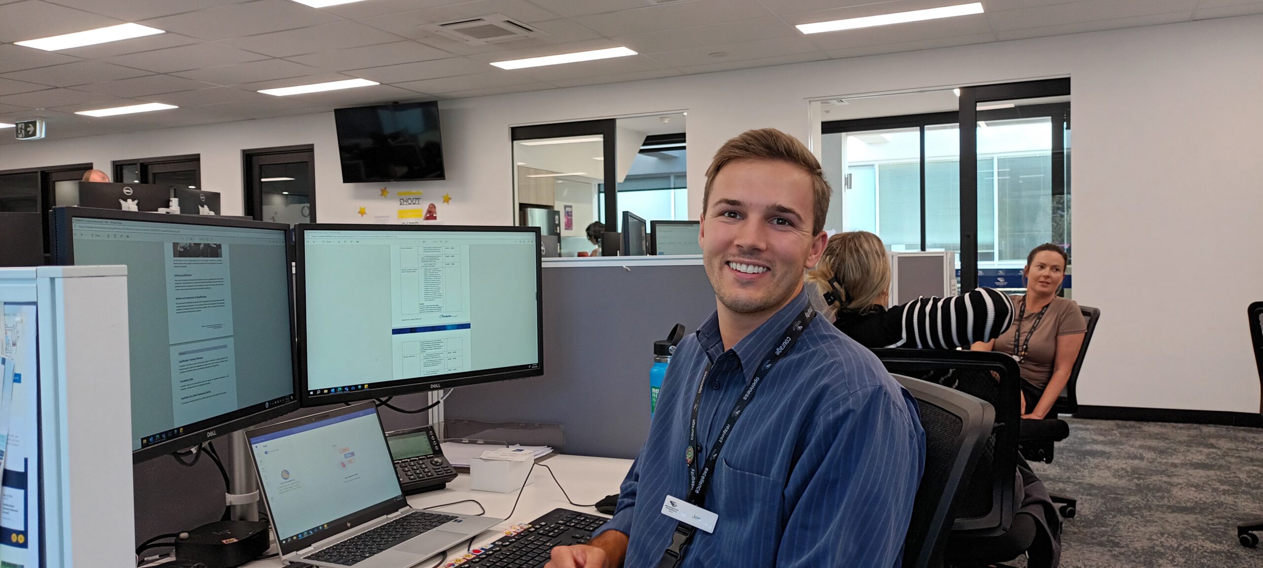 Joe Collins smiling at computer desk
