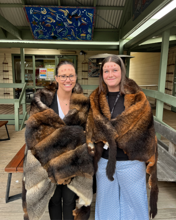 Sarah and Ava wearing fur skin cloaks